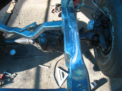 1976 Ford F-250 - Close-up view of a truck's frame and rear axle during a build or repair process.