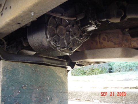 1979 Ford Bronco - Underside view of a vehicle's transfer case, supported by green wooden blocks. The date stamp reads SEP 21 2003.