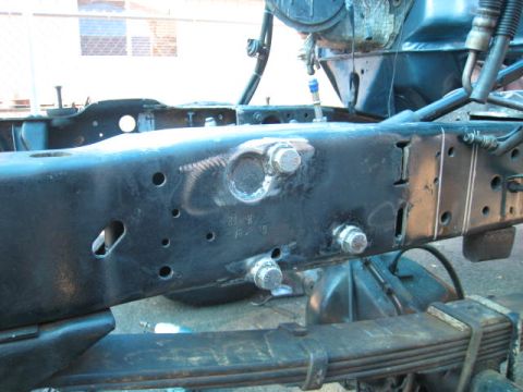 1976 Ford F-250 - Close-up view of a truck's frame and suspension system, showing various bolts and structural elements.