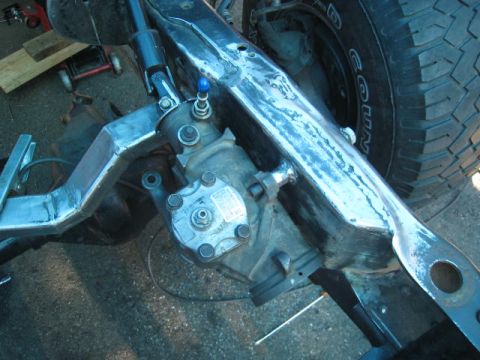 1976 Ford F-250 - Power steering gearbox and frame components are visible in this close-up shot. Supermotors.net logo present.
