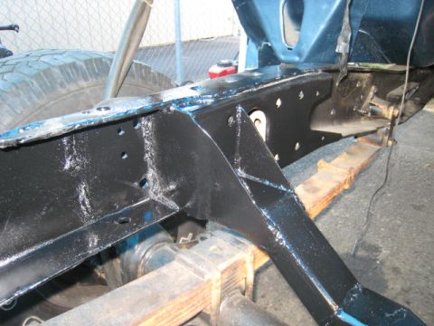 1976 Ford F-250 - The frame of a 1976 Ford F-250 is shown from a low angle, highlighting its painted chassis components.