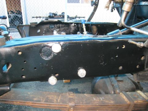1976 Ford F-250 - Detail shot of a truck's chassis, showing the frame and leaf spring assembly.