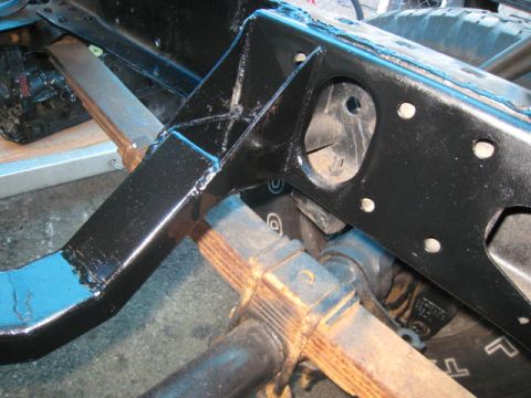 1976 Ford F-250 - The frame and suspension components of a truck are shown in this close-up view.