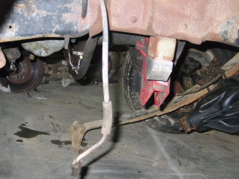 1984 Ford Bronco - Close-up view of the undercarriage, showing suspension parts and a tire.