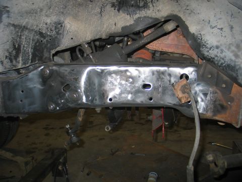 1984 Ford Bronco - Close-up view of a vehicle's frame and suspension system, indicating repair or modification work.