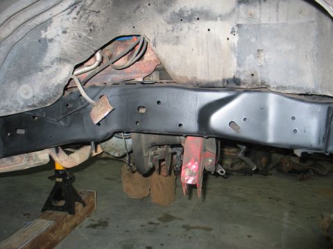 1984 Ford Bronco - Close-up view of the undercarriage of a vehicle, showing the frame and suspension parts.