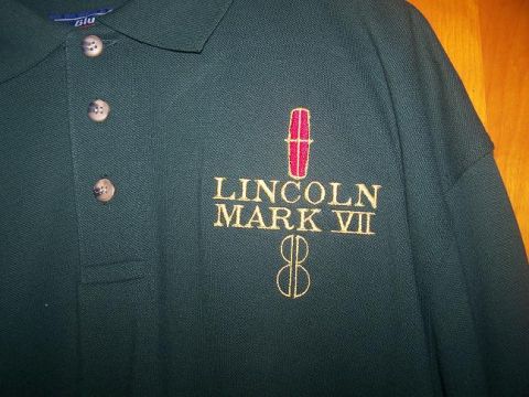 1987 Lincoln Mark VII - A close-up of a dark green polo shirt embroidered text and the Lincoln logo.