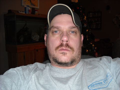 1979 Ford F-150 - A man in a baseball cap and t-shirt poses for a selfie indoors, with a Christmas tree visible behind him.