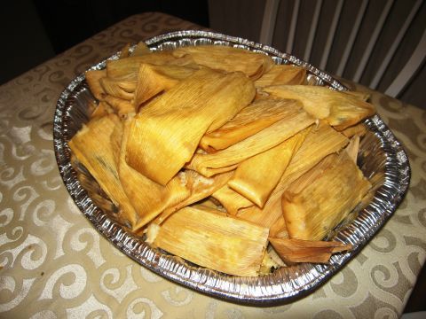 1986 Ford Bronco - A large aluminum pan filled with tamales wrapped in corn husks sits on a table.