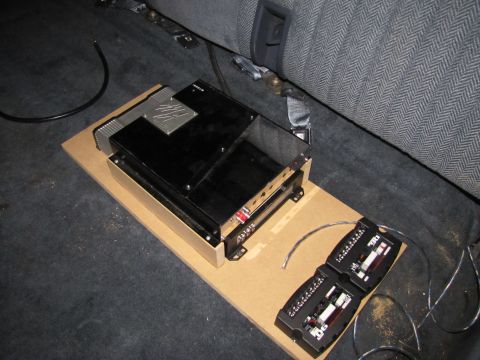 1993 Ford F-250 - Audio amplifiers and wiring are installed in the interior of a vehicle, placed on a wooden board.