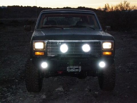 1982 Ford Bronco - Front view of a Ford Bronco, equipped with auxiliary lighting and a winch, at dusk.