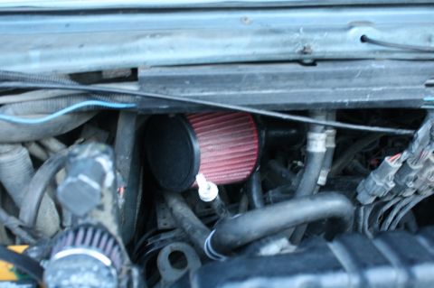 1989 Ford Bronco - Aftermarket air filter installed in the engine bay, surrounded by hoses and wiring.