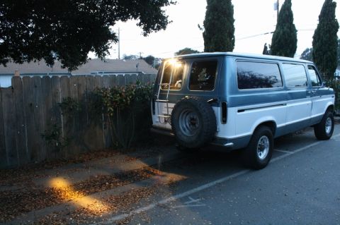 1989 Ford Bronco - This van features a two-tone paint scheme and a rear-mounted spare tire, suggesting it is ready for adventure.