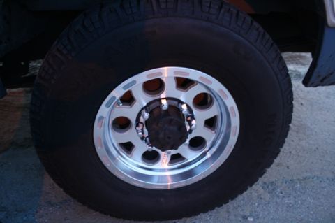1989 Ford Bronco - Aftermarket wheel and tire assembly on a vehicle.