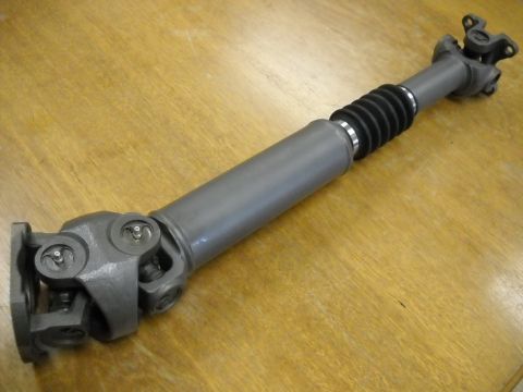 1991 Ford Bronco - A driveshaft, likely a replacement part, is shown on a wooden table.