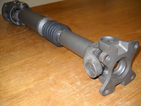 1991 Ford Bronco - Driveshaft part shown on a wooden table with a SuperMotors logo at the bottom right.