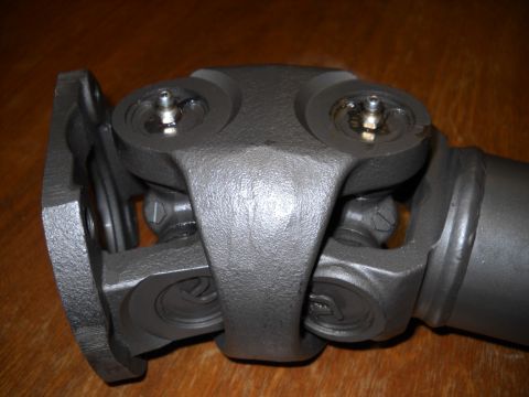1991 Ford Bronco - Close-up of a driveshaft universal joint, showing its components and grease fittings.