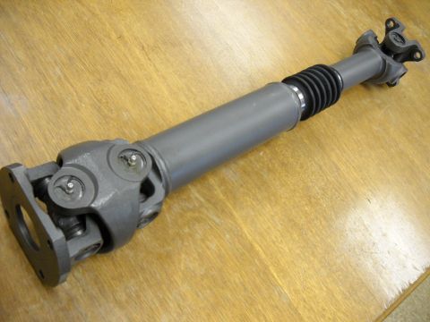 1991 Ford Bronco - Driveshaft assembly with U-joints and a protective rubber boot.