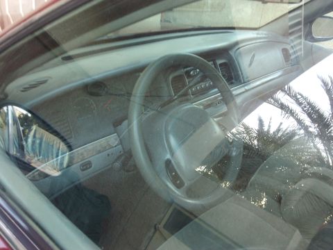 1998 Ford Crown Victoria - Interior view of a 1998 Ford Crown Victoria, captured through the windshield.