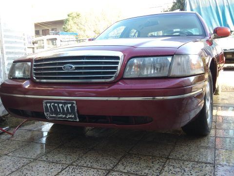 1998 Ford Crown Victoria - This Ford Crown Victoria has a distinctive grille and headlight design, indicating a later model year than claimed.