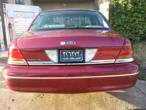 1998 Ford Crown Victoria - Rear view of a red 1998 Ford Crown Victoria sedan.