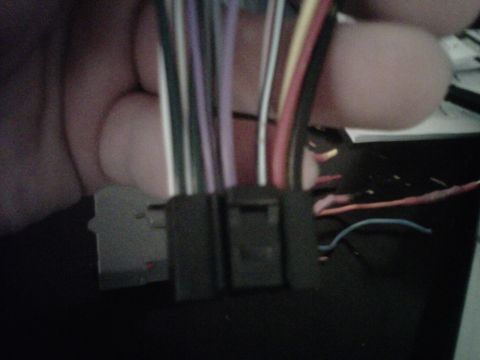 1993 Ford Bronco - A close-up view of a wiring harness connector with various colored wires.