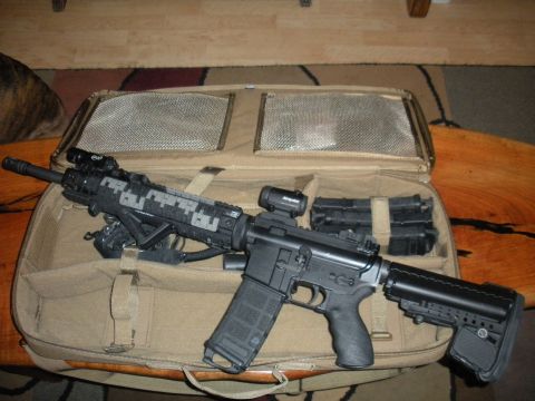 1996 Ford Bronco - AR-15 style rifle with accessories and magazines stored in a tan case.