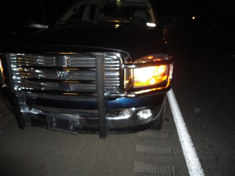 2006 Dodge 2500 - Front view of a dark blue pickup truck a chrome grille and brush guard, likely a 2006 Dodge 2500.
