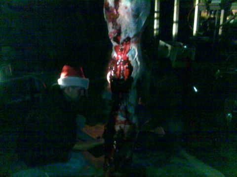 2006 Dodge 2500 - A person in a Santa hat stands near a bloody carcass, with a Supermotors watermark visible.