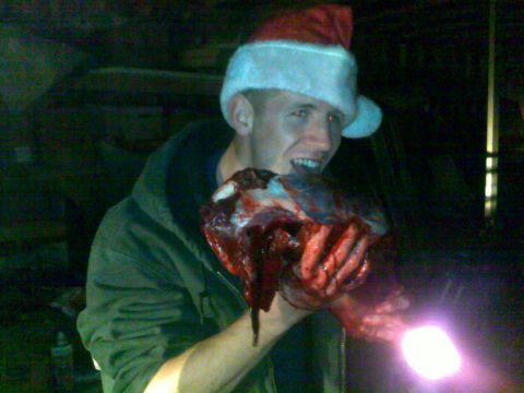 2006 Dodge 2500 - A man wearing a Santa hat holds a large piece of raw meat, with a Supermotors.net watermark visible.