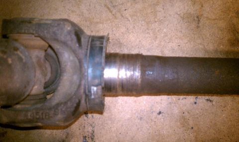 1994 Ford F-150 - Close-up of a driveshaft yoke showing wear and a stamped part number.