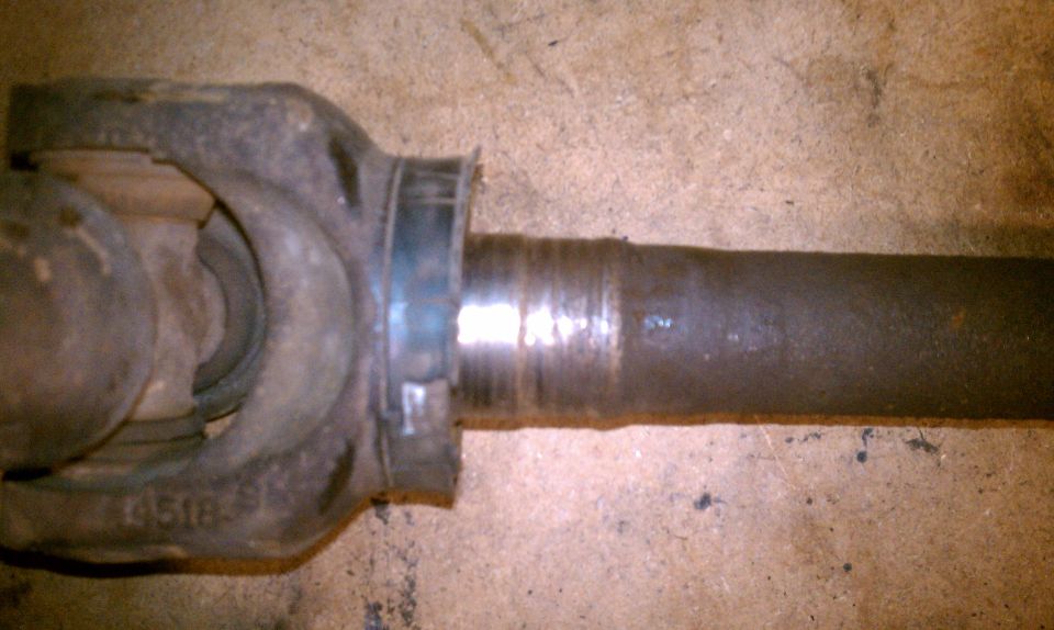 Driveshaft yoke with visible wear marks and a part number 4518