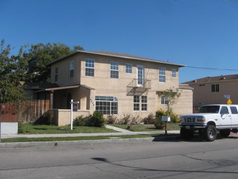 1968 Ford Mustang - A tan two-story apartment building is shown with a white pickup truck parked in the driveway.
