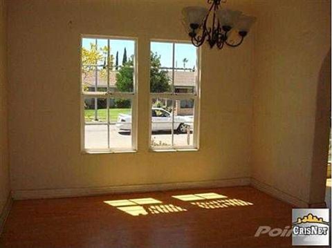1968 Ford Mustang - A white car is visible parked on the street outside a house, seen through a window.
