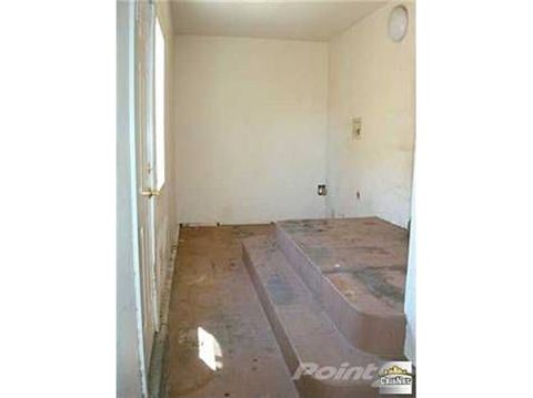 1968 Ford Mustang - Interior room with a raised platform and steps, bare walls, and a door.