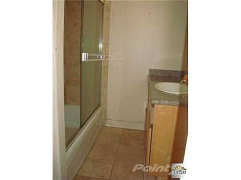 1968 Ford Mustang - A bathroom scene a bathtub with a glass shower door and a vanity with a sink.