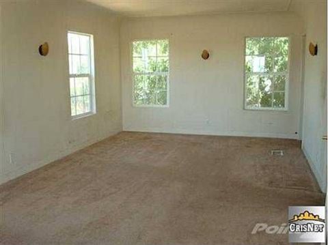 1968 Ford Mustang - This is an interior view of a room with carpet and three windows.