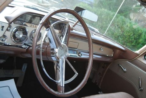 1991 Ford LTD Crown Victoria - The dashboard of a vintage automobile features a prominent steering wheel and classic gauges.