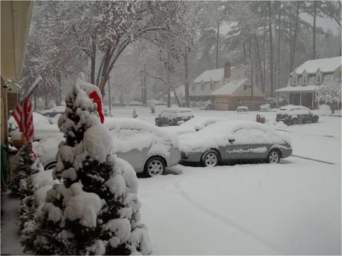 1972 Ford Ranchero - A winter scene shows multiple vehicles buried under a blanket of snow on a residential street.