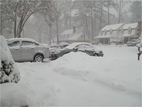 1972 Ford Ranchero - Snowfall blankets parked cars and the surrounding neighborhood, creating a winter scene.