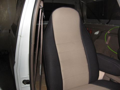 1995 Ford Bronco - The interior of a vehicle is visible, focusing on the driver's seat with its distinctive two-tone seat cover.