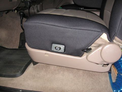 1995 Ford Bronco - Interior view of a car seat with a protective cover and visible adjustment controls.