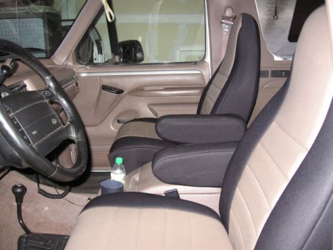 1995 Ford Bronco - Interior of a 1995 Ford Bronco with two-tone seat covers installed on the front seats.