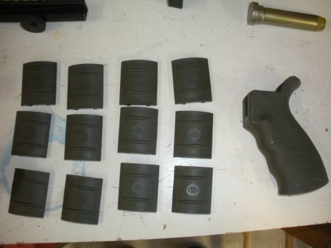 1996 Ford Bronco - Collection of pistol grips and firearm components laid out on a table.