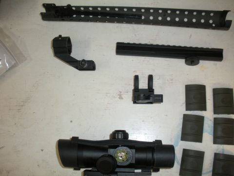 1996 Ford Bronco - Various firearm components, including a scope and rail system, are arranged on a surface.