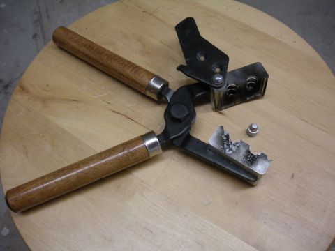 1996 Ford Bronco - Tool for casting bullets, shown with a mold and a single lead projectile.