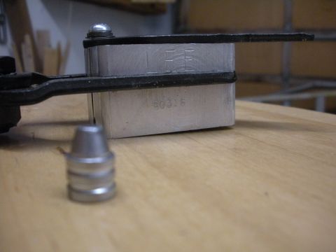 1996 Ford Bronco - Close-up of a stamped metal part with identifying numbers and letters visible.