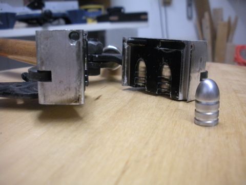 1996 Ford Bronco - A bullet mold is shown with bullets inside and one separate bullet, suggesting a reloading process.