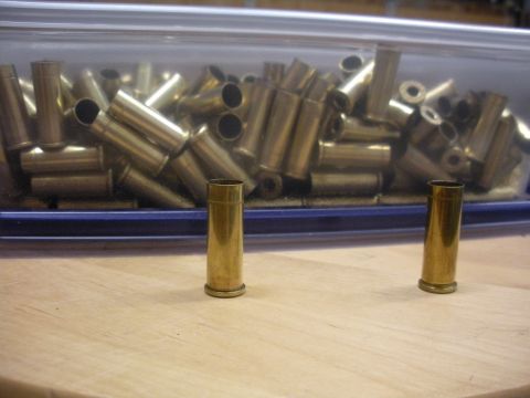 1996 Ford Bronco - A collection of brass shell casings are visible in a clear container, with two casings prominently displayed in front.