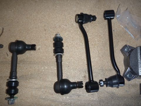 1997 Dodge 2500 - Various automotive suspension components are displayed on a workbench surface.